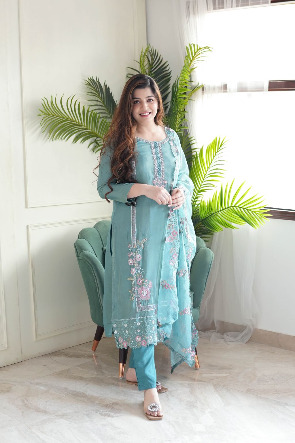 Delicate floral detailing adorns this pastel green embroidered kurta set.