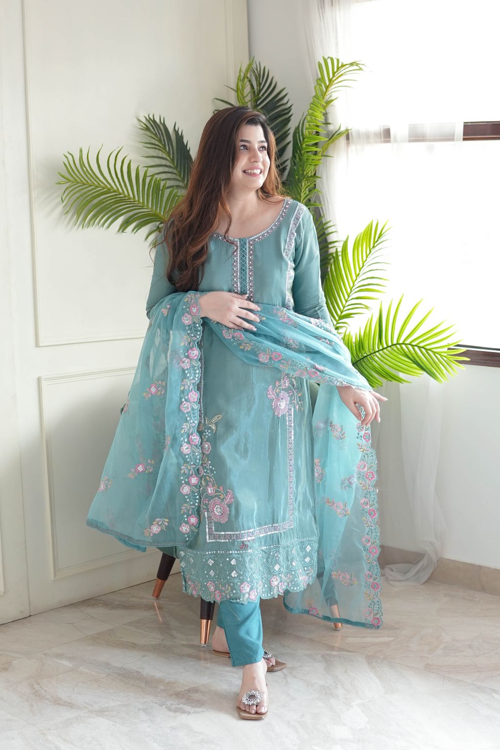 Delicate floral detailing adorns this pastel green embroidered kurta set.